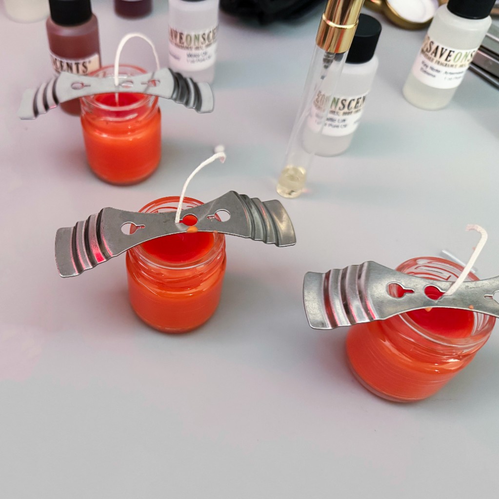 Hand-poured martial scent candles with duty wick holders in a workspace